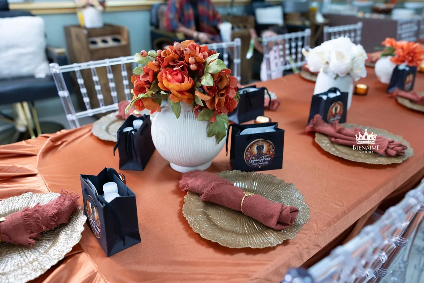 Brunch table set with florals, gold chargers and LegacyTress gift bags
